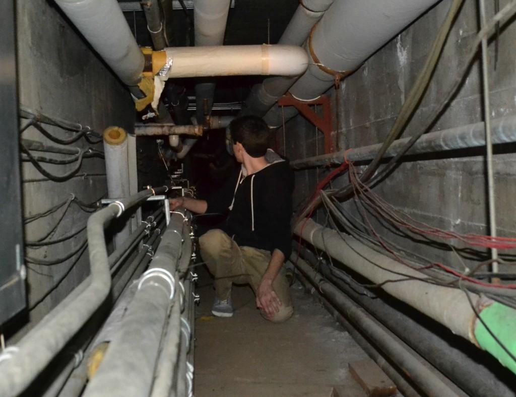 Staff member Spencer Seeberger gazes into the depths of the abysmal Bellarmine tunnels.