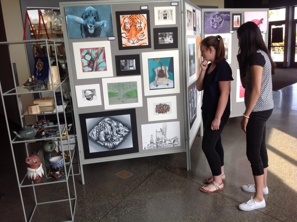 Freshmen+Cristina+Shaffer+and+Ali+Lo+contemplate+the+artwork+of+their+peers.+Photo+by+Jeanne+Hanigan