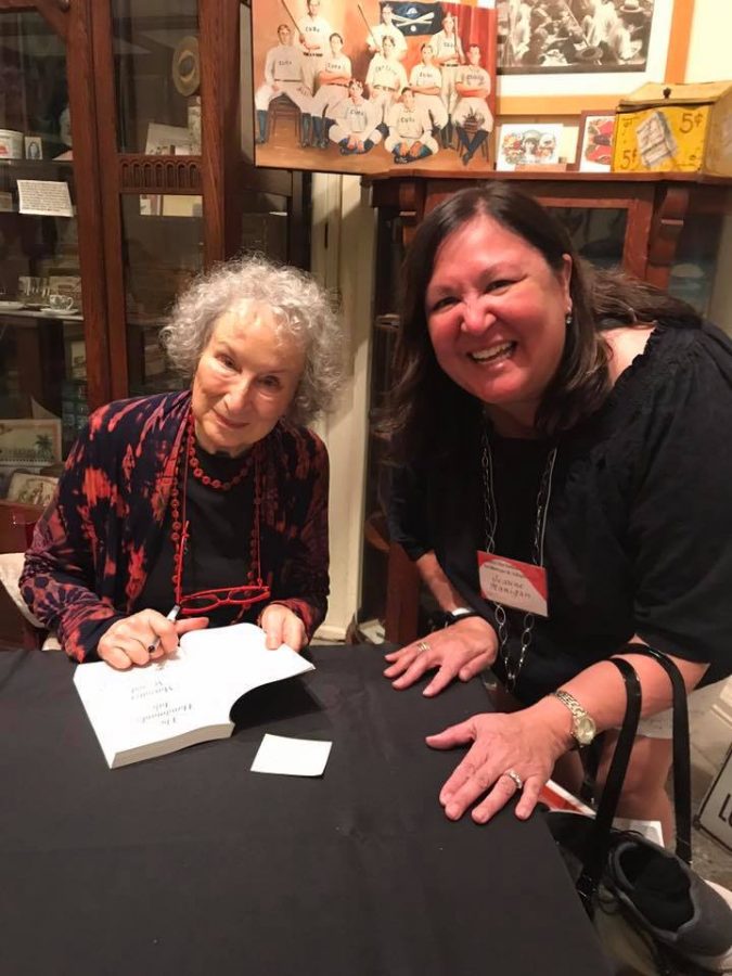 Margaret Atwood signs a copy of "The Handmaid's Tale" for a giddy English teacher. Does Atwood seem to be a more mature doppelganger of of a Bellarmine teacher? Photo by Jim Hanigan 