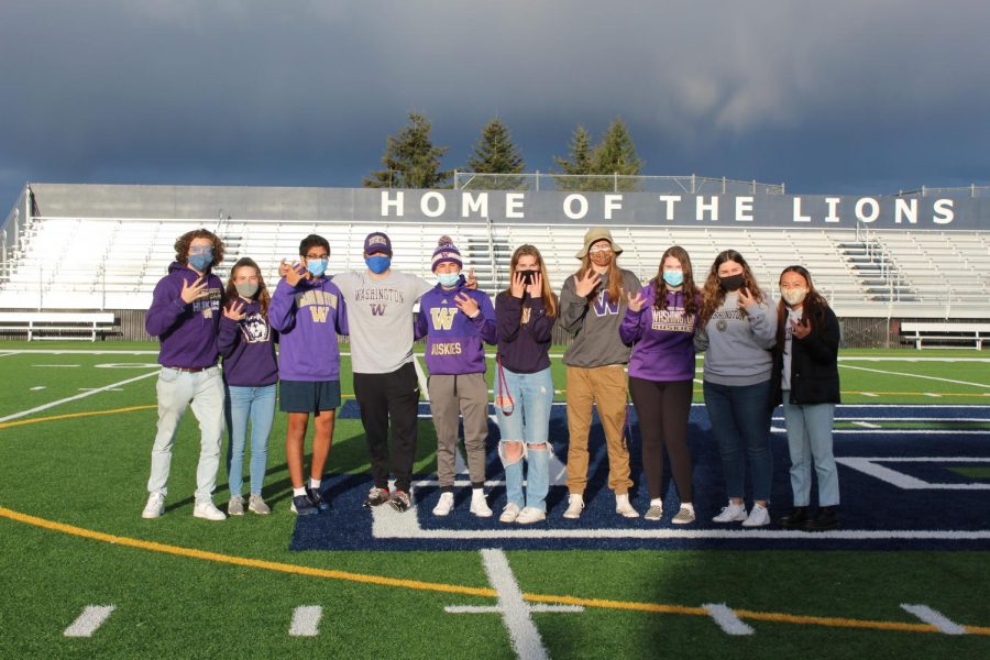 The seniors attempt the W sign to represent the University of Washington. 