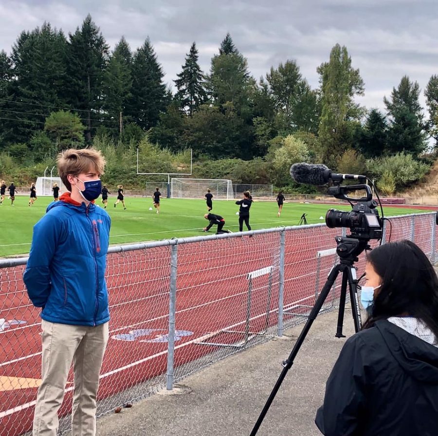 Broadcast staff Tashi Landers-Quinn and Maren Jones watch the OL Reign practice. 