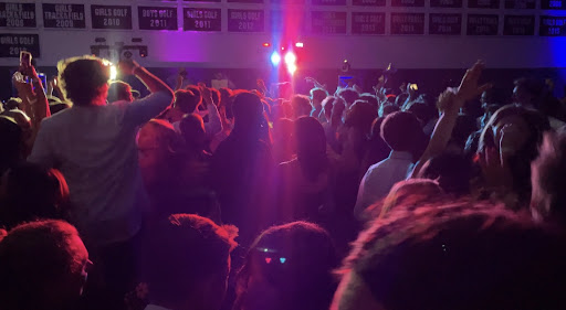 Students dance the night away on the gym floor.