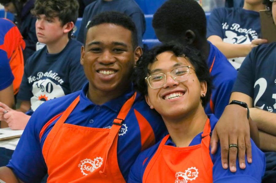 Mark Manaois (B’23) and Ben Fowlkes (B’23) smile during a robotics competition. 