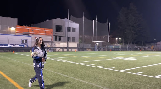 Stephanie Hillyer walks the field during the homecoming royalty ceremony. 