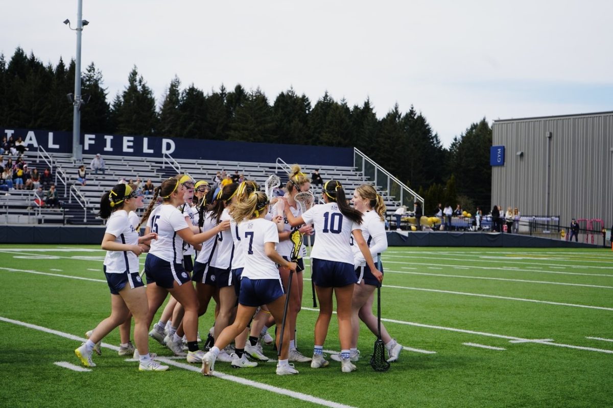 The lacrosse team mobs Grace Zimmerman after her 8 meter. Photo courtesy of Alexis Douglas