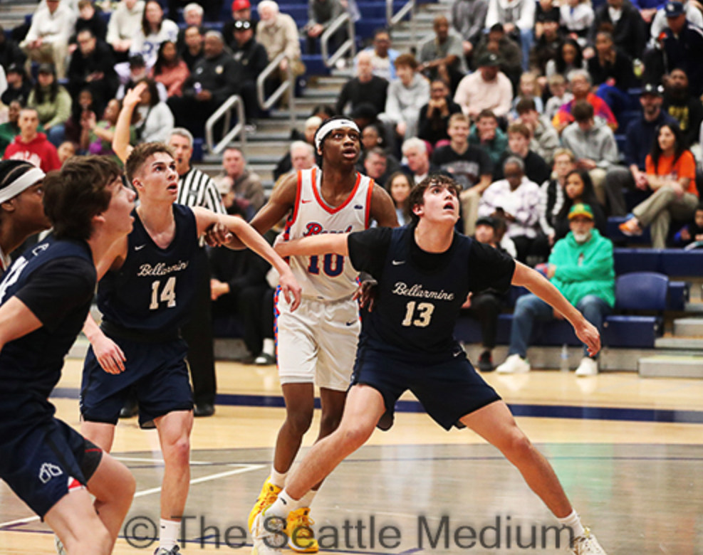 Ben Heisel (#13), J.J. Bordeaux (#14) and Birk Johnston (#12) box out for a rebound. Photo courtesy of SeattleMedium.com (Aaron Allen)