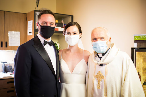 The newly-wedded Unruhs alongside Fr. Jerry. Photo courtesy of Connor Unruh